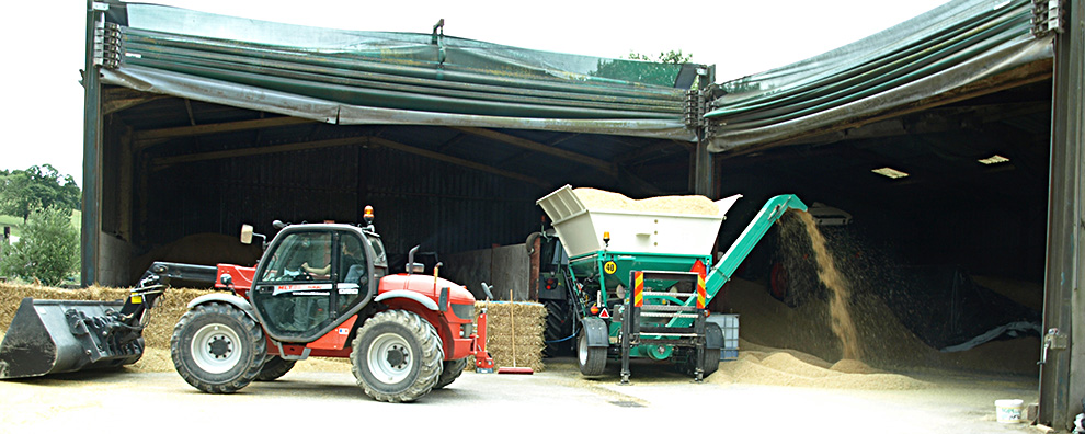 Farmyard scene showing wheat being crimped and ensiled